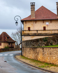 Street by building against sky