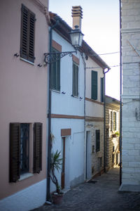 Empty alley amidst buildings in city