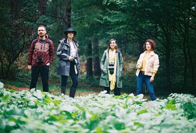 Portrait of backpackers standing in forest