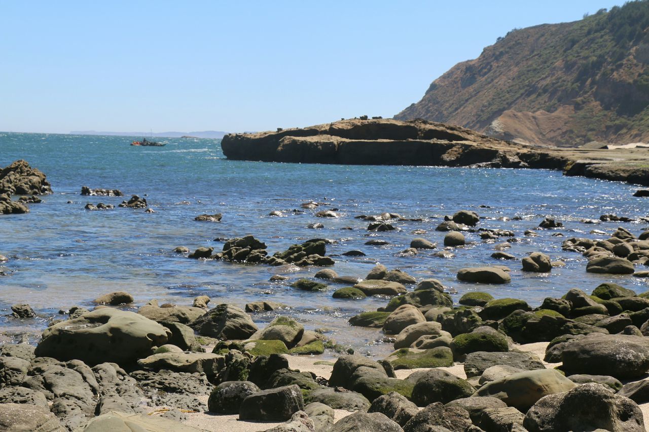 water, sea, rock - object, clear sky, tranquil scene, scenics, tranquility, beauty in nature, rock formation, rock, nature, horizon over water, beach, blue, mountain, shore, idyllic, sky, stone - object, rocky