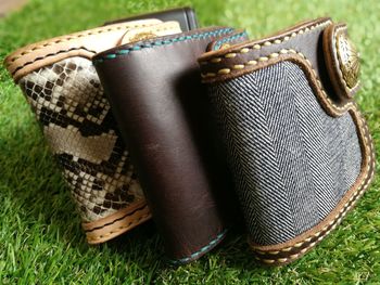 Close-up of wallets on grassy field