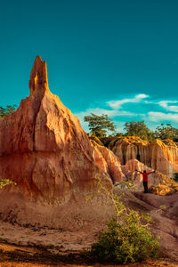 Tourists dwarfed by the rock formations at marafa depression - hell's kitchen at sunset in kenya