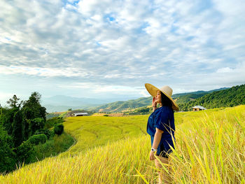 Full length of man wearing hat on field against sky
