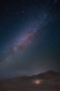Scenic view of star field over desert against sky at night