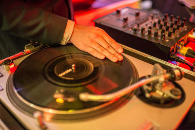 Midsection of man playing records