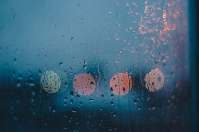 Full frame shot of raindrops on glass window