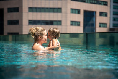 Rear view of couple in swimming pool