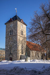 Low angle view of clock tower against clear sky