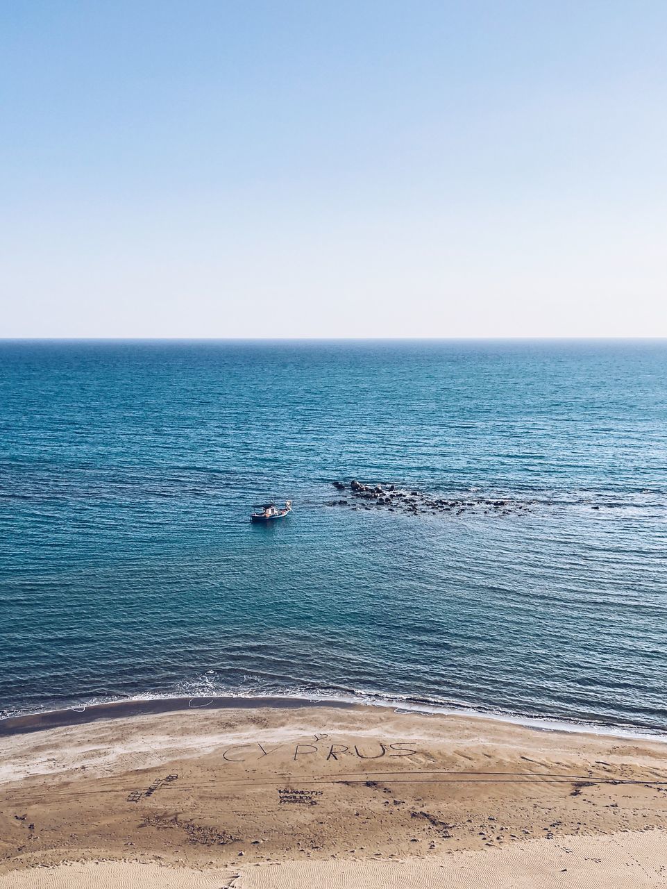 SCENIC VIEW OF BEACH AGAINST CLEAR SKY