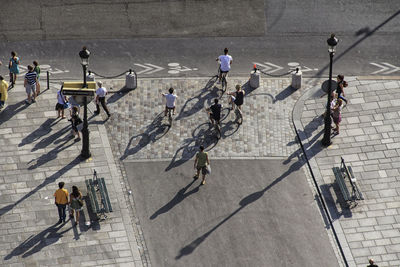 High angle view of people walking on road