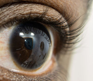 Close up of african american mans dark brown eyes for use in ophthalmology optometry imagery