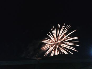 Low angle view of firework display at night