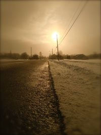 Scenic view of snow covered landscape at sunset