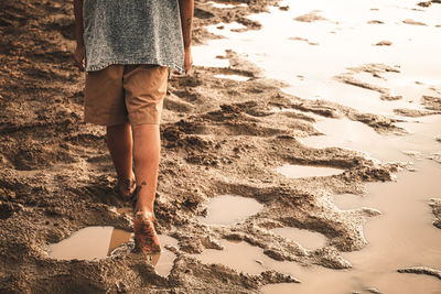 Low section of woman standing on beach