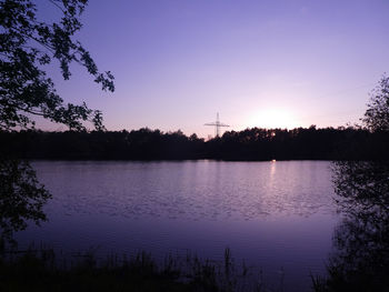 Scenic view of lake against sky at sunset