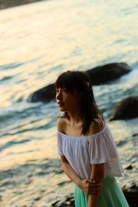 Woman in front of sea