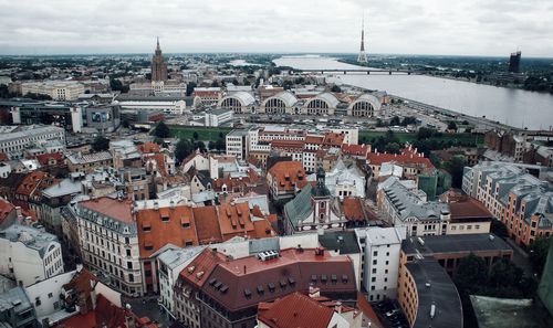 High angle view of cityscape by sea against sky