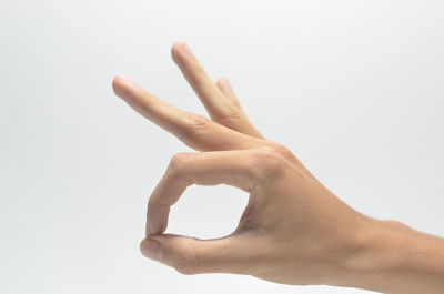 Close-up of human hand against white background