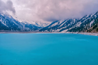 Scenic view of lake against sky during winter