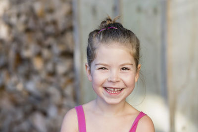 Close up portrait of young girl smiling at the camera