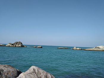 Scenic view of sea against clear blue sky