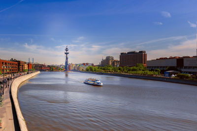 Bridge over river in city against sky