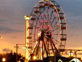 Low angle view of ferris wheel against sky