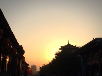 Low angle view of buildings against sky at sunset