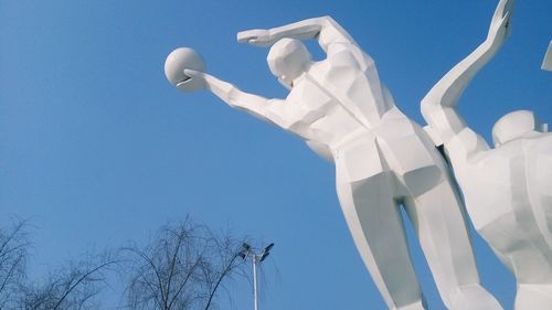 Low angle view of statue against blue sky