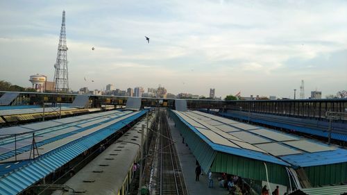 High angle view of city buildings against cloudy sky