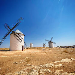 Scenic view of windmills against clear sky