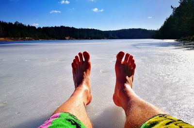 Low section of two people relaxing on water