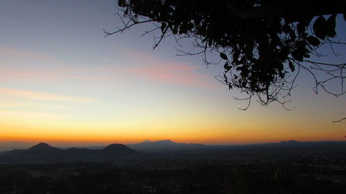 Scenic view of mountains against sky at sunset