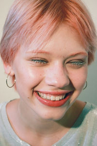 Close-up portrait of smiling young woman