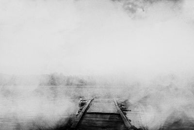 View of pier over lake against sky