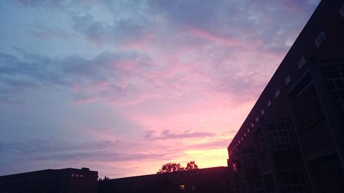 Low angle view of silhouette buildings against sky