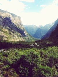 Scenic view of mountains against cloudy sky