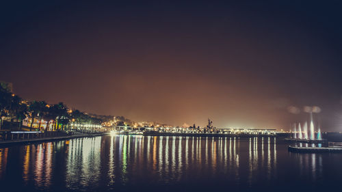 Illuminated city at waterfront