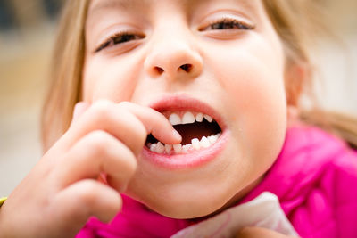 Close-up portrait of young woman eating