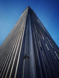 Low angle view of modern building against clear blue sky