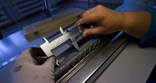 Cropped image of hands using vernier calliper in workshop