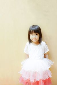 Portrait of girl standing against white background