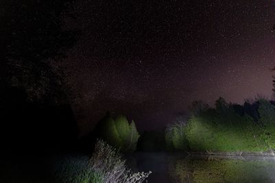 Scenic view of lake against star field at night