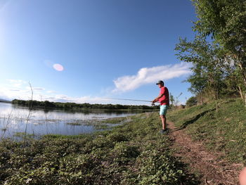 Rear view of man walking against sky