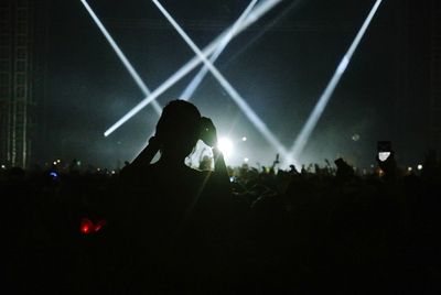 Rear view of woman looking at crowd during music concert