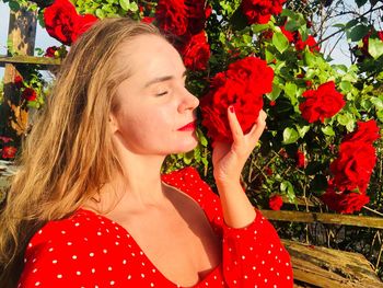 Portrait of woman with red flowers