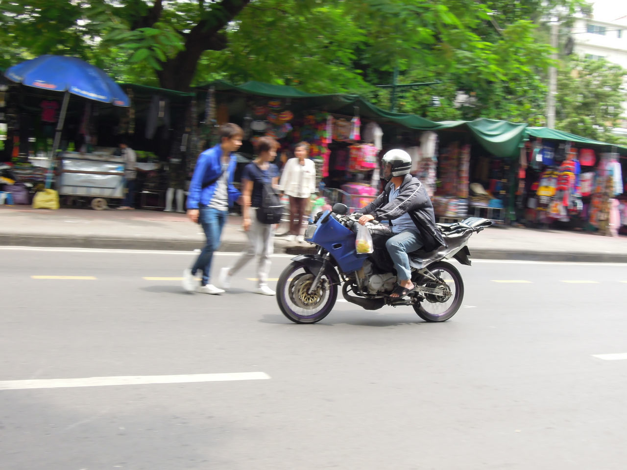 PEOPLE RIDING BICYCLE ON ROAD