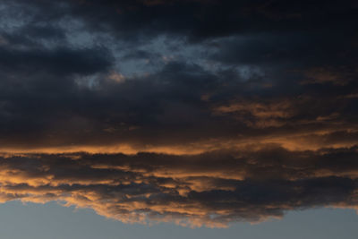 Low angle view of storm clouds in sky during sunset