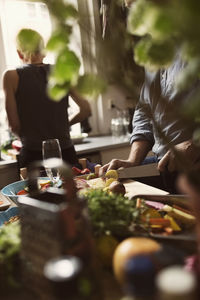 Friends preparing food in kitchen