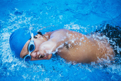 Paralympic young swimmer crawling in a pool